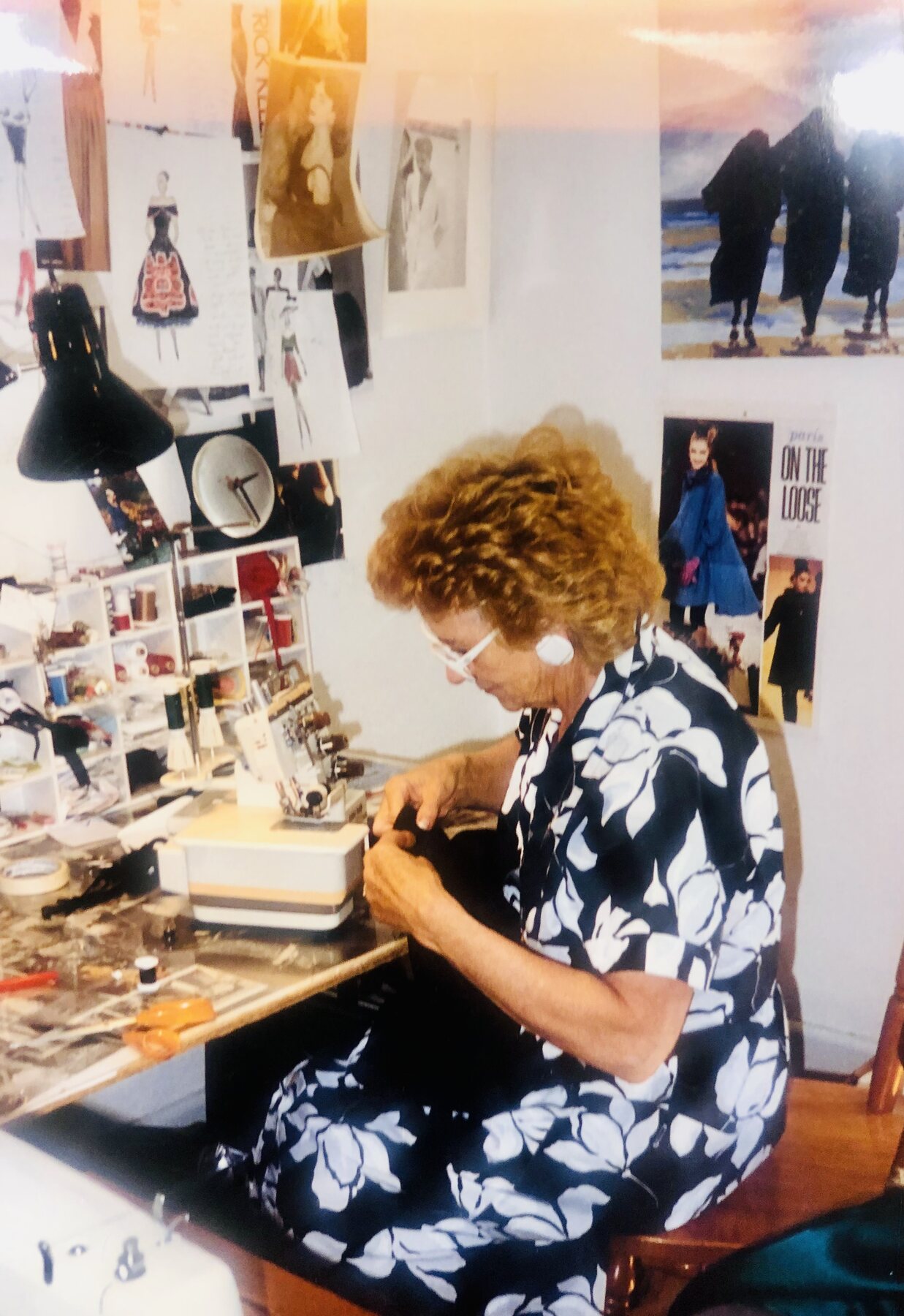 A beadworker at a lamp-lit desk