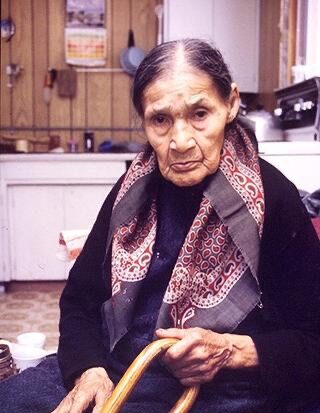 Margaret Moses, seated, with a cane. A family photograph.
