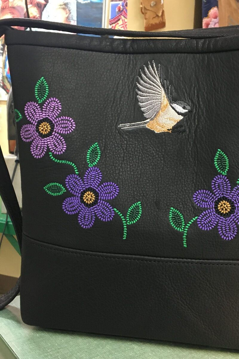 Black leather bag with a chickadee and purple flowers