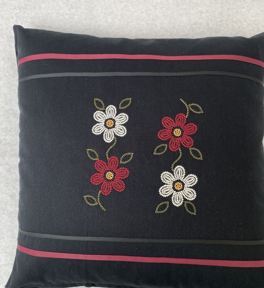 Black pillow with four beaded flowers